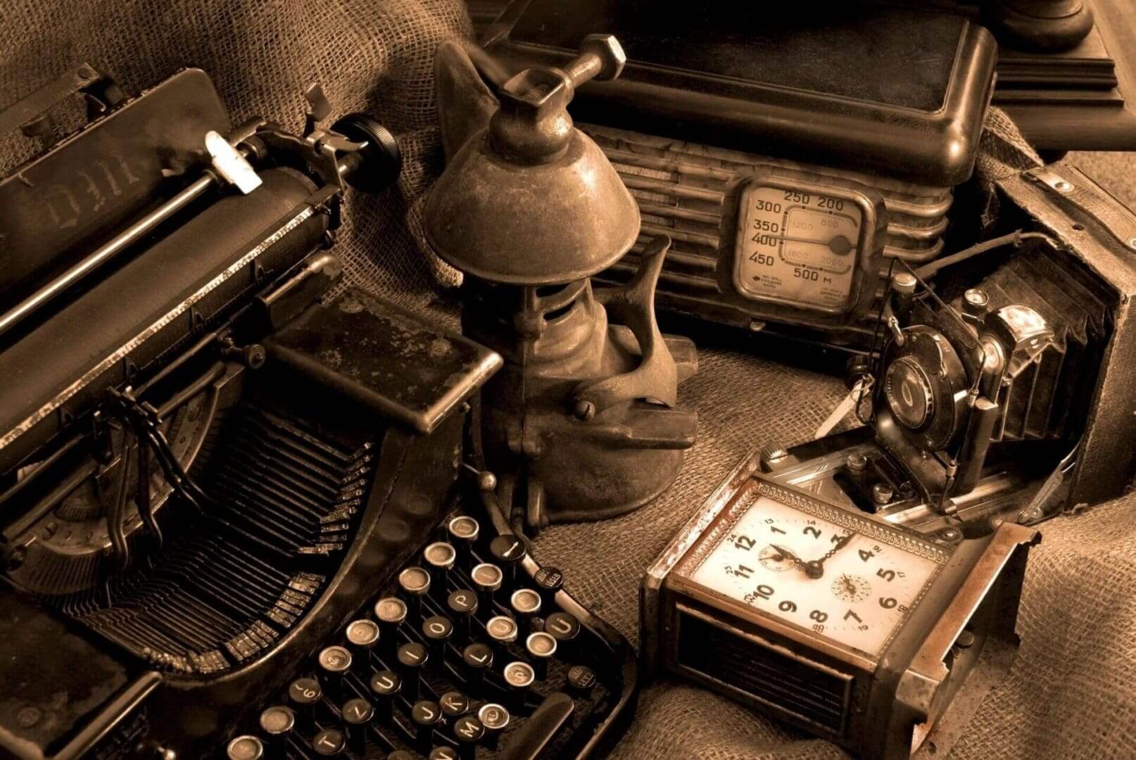 A vintage typewriter and other items are sitting on the floor.