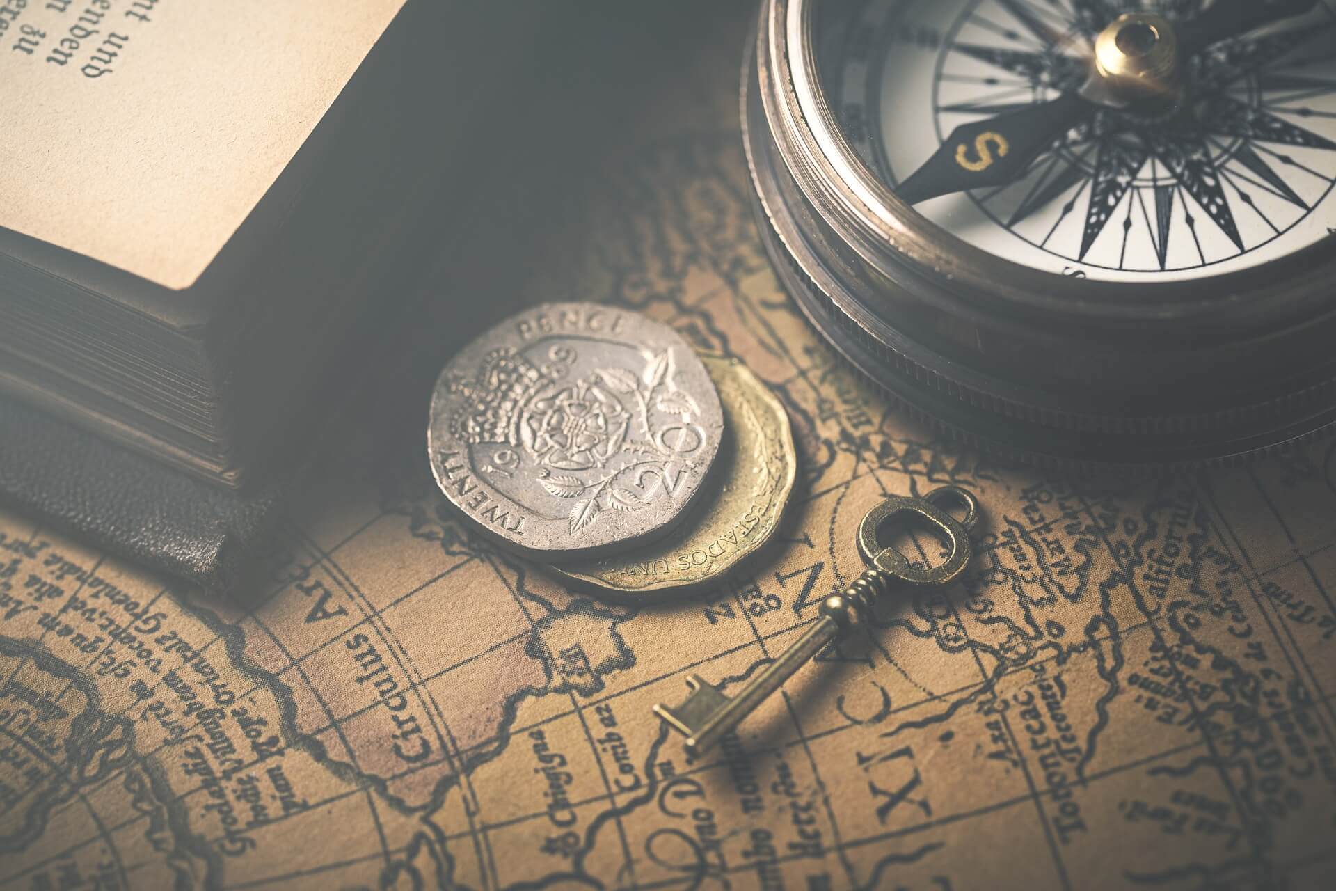 A map with a compass and two coins on it