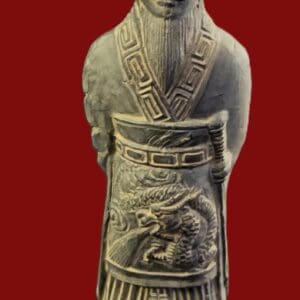 Ancient statue with intricate dragon and geometric carvings on its robe.