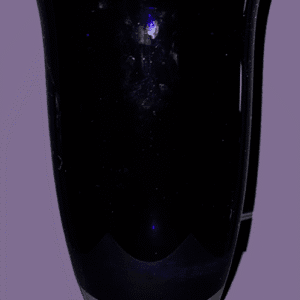 A dark, reflective surface with faint blue light spots.