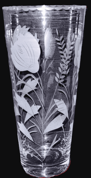 Clear glass vase with intricate leaf and floral engravings.