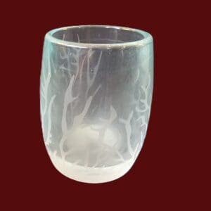 A frosted glass tumbler with a delicate frosted deer design.
