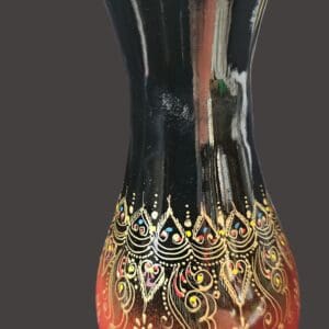 Decorative vase with intricate gold patterns and gradient colors.