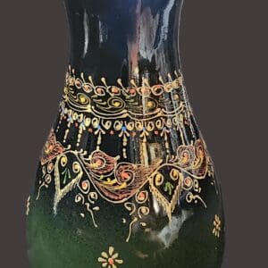 A decorative vase with intricate gold and red embellishments.