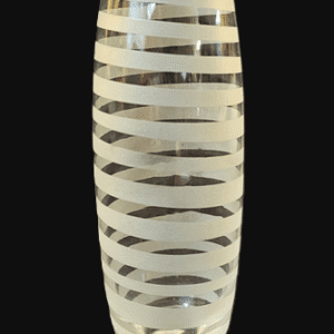 Tall glass vase with white spiral stripes on a clear background.