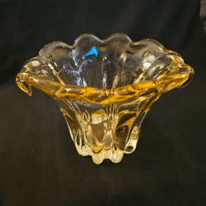 Elegant amber glass bowl with a wavy, flared edge.