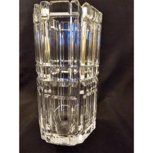 Clear glass vase with geometric patterns on a dark background.