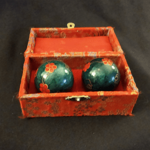 Pair of green Baoding balls in a decorative red box.