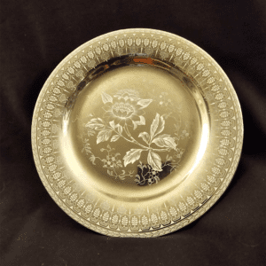 Ornate golden plate with floral design and detailed border.