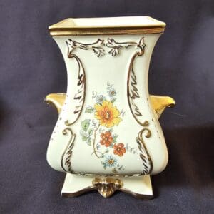 Ornate vintage ceramic vase with floral patterns and gold accents.