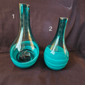 Two blue glass vases with unique shapes and numbered labels on a dark background.