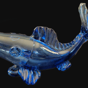 A shiny blue glass fish sculpture with detailed fins.