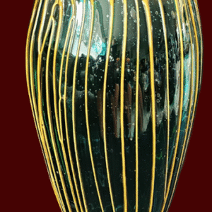 Tall black vase with vertical gold stripes on a red background.