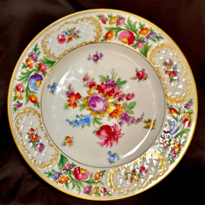 Ornate floral patterned porcelain plate with intricate gold detailing.