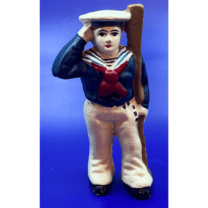 Vintage ceramic sailor figurine saluting with a rifle on his back.