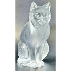 A silver cat figurine sitting upright with detailed features.
