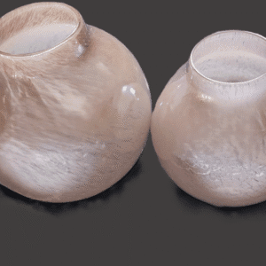 Two handcrafted ceramic vases with textured surfaces on a dark background.