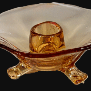Elegant amber glass candle holder with a wide, flared rim and tripod base.
