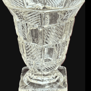 Intricately carved clear crystal vase with geometric patterns.