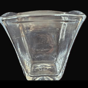 Clear glass vase with a flared top and square base.