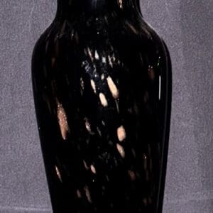 Black ceramic vase with reflective surface and abstract light patterns.