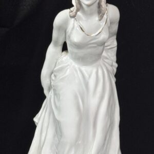 White marble statue of a woman in a flowing dress.