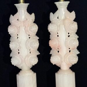 Intricately carved white stone sculptures with detailed floral and leaf patterns.