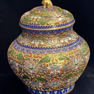 Ornate, colorful ceramic jar with intricate floral patterns and a lid.