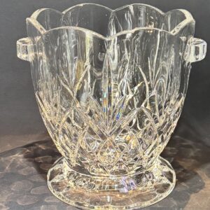 Elegant crystal ice bucket with intricate cut designs and handles.