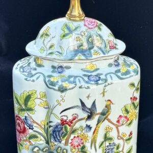 Decorative porcelain jar with floral and bird motifs.
