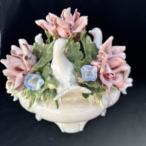 Elegant porcelain centerpiece with white bird and pastel flowers.