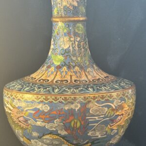 Intricately decorated antique vase with colorful floral and geometric patterns.