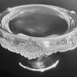 Elegant silver pedestal bowl with intricate floral designs.