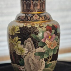 Ornate cloisonné vase with floral and rock motifs.